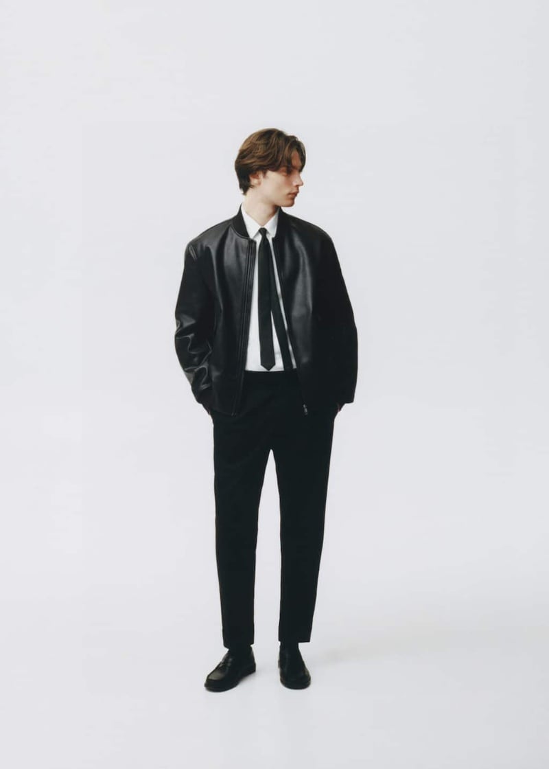 In front and center, Freek Iven dons a leather bomber jacket over a white shirt and tie from Mango.