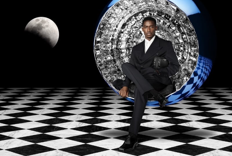 Damson Idris commands attention in an impeccably tailored suit for Prada's holiday 2023 campaign.