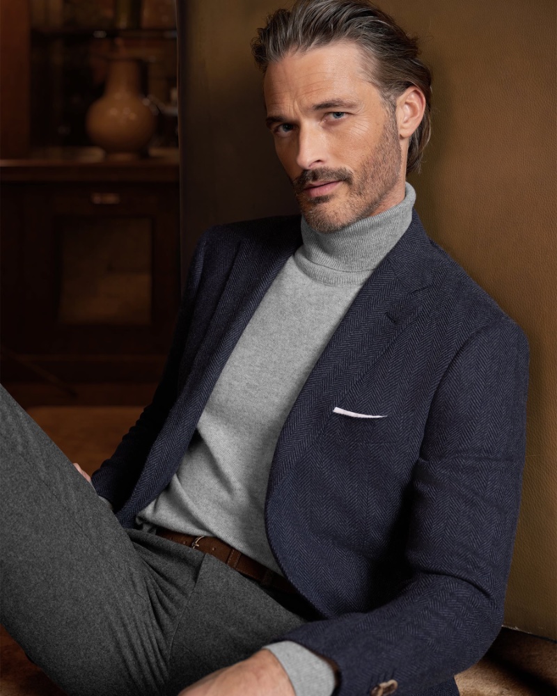 Ben Hill exemplifies timeless elegance in Proper Cloth's winter 2023 line, showcasing a herringbone blazer and ash turtleneck.