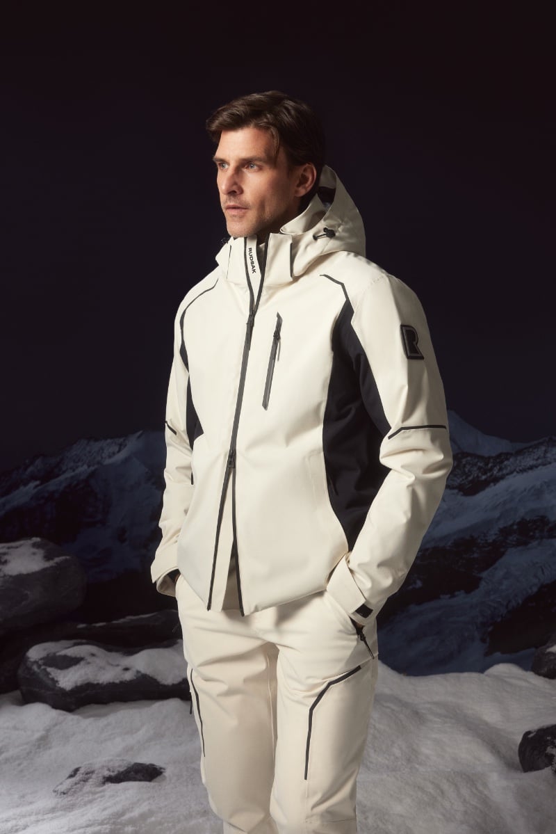 Johannes Huebl strikes a pose in a crisp white RUDSAK ski suit.