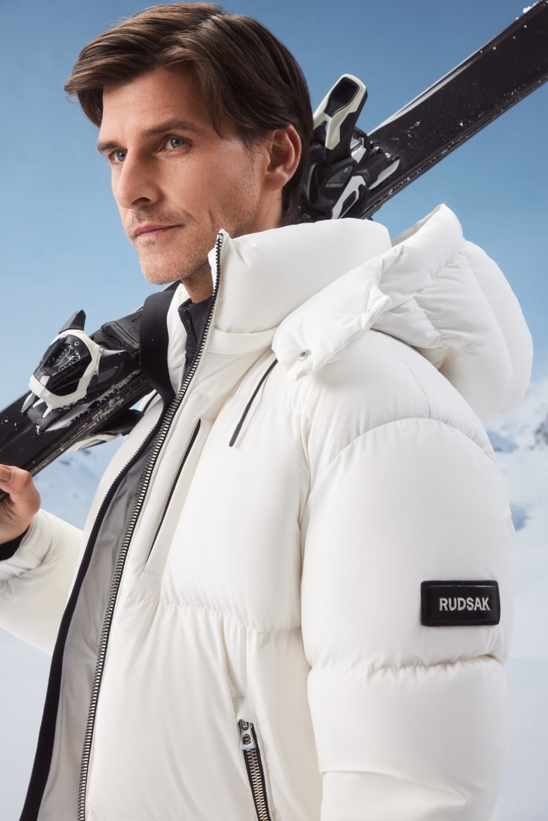 Johannes Huebl, ready for the slopes, exudes effortless chic in a white puffer jacket by RUDSAK.