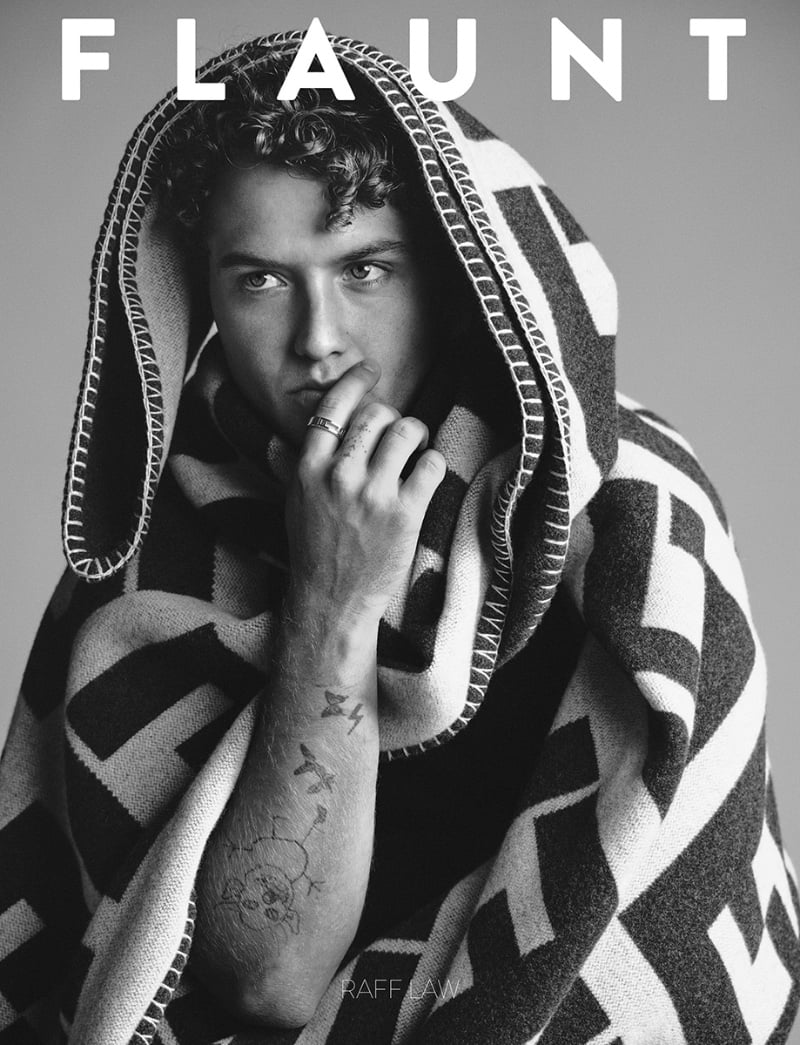 Raff Law, draped in a Fendi blanket, covers Flaunt magazine, highlighting his arm tattoos.