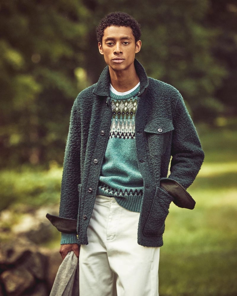 In front and center, Jecardi Sykes layers a Todd Snyder boucle chore jacket over a patterned sweater. 