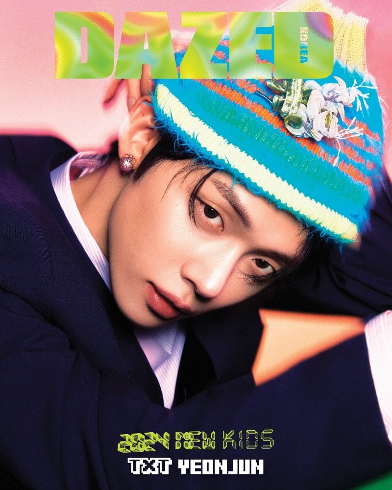 Yeonjun strikes a charismatic pose in a vibrant Dior Men beanie and sleek suit for the cover of Dazed Korea.