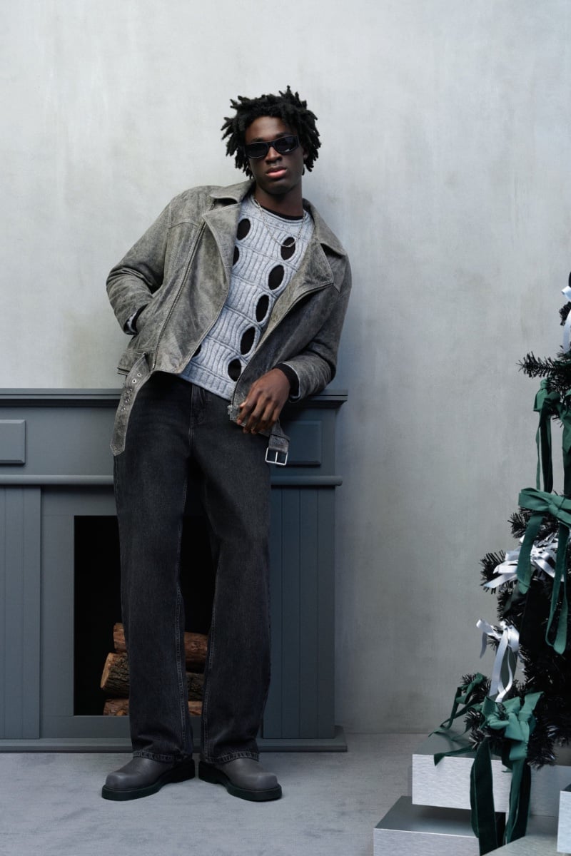 Nana Duncan models a grey washed leather jacket, an openwork sweater, and sunglasses.