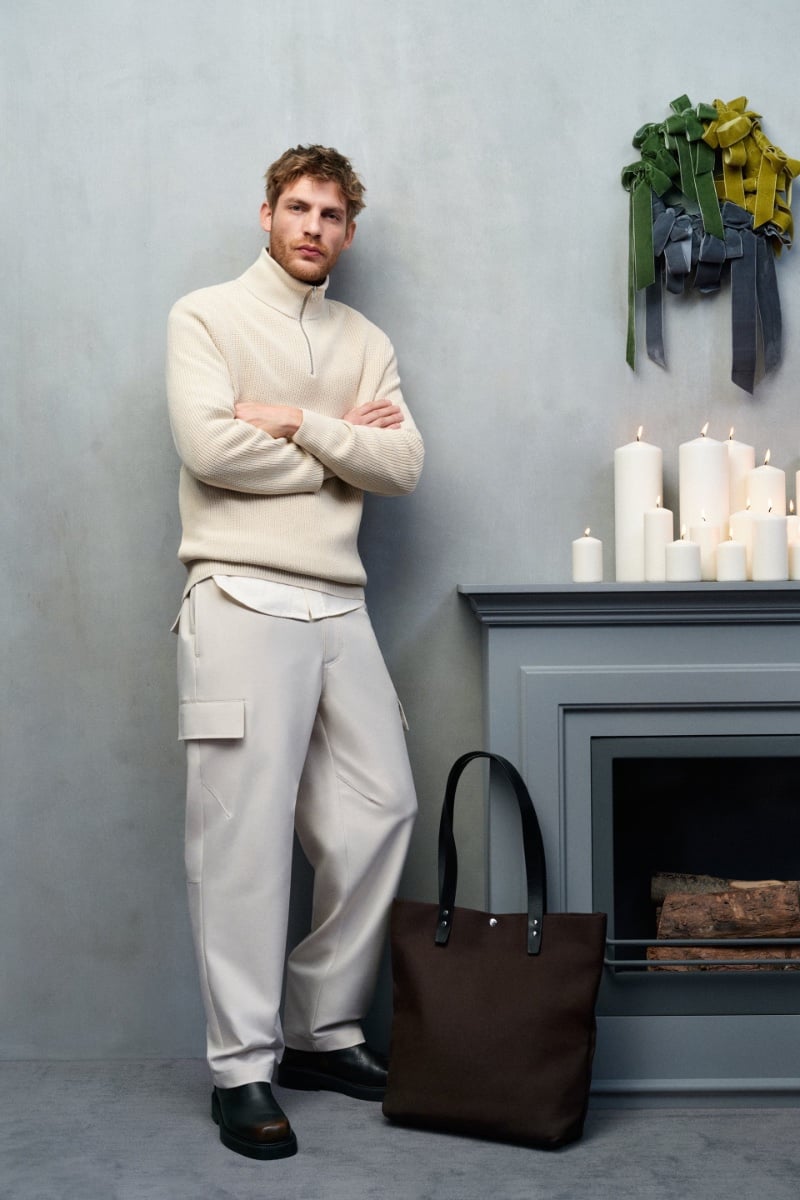 Embracing smart casual style, Baptiste Radufe dons a chic cream turtleneck pullover and cargo pants.