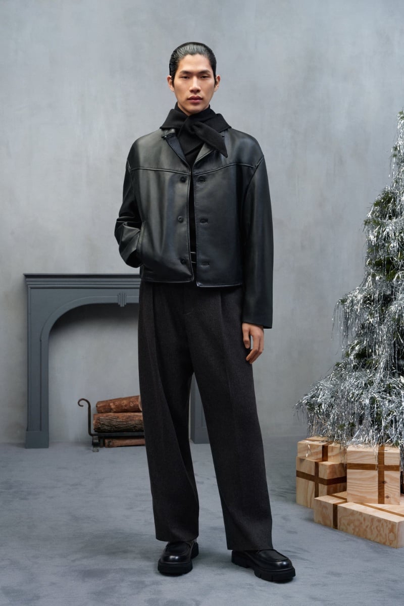 Sanggun Lee channels an elevated cool in a leather jacket and wide-legged trousers.