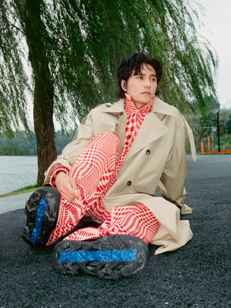 Chen Kun wears a Burberry trench with a warped houndstooth nylon blend outfit for the brand's Lunar New Year 2024 advertisement. 