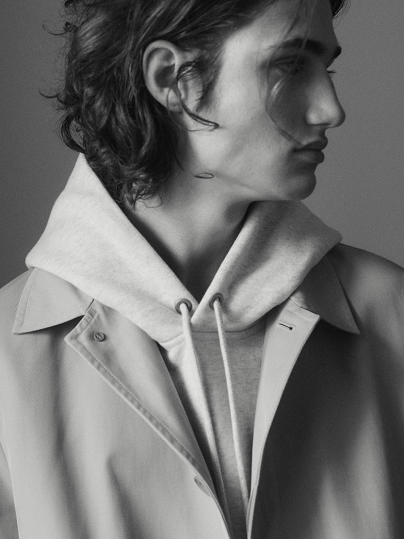Appearing in a black-and-white photo, Dawson Bray layers in COS' newest arrivals.