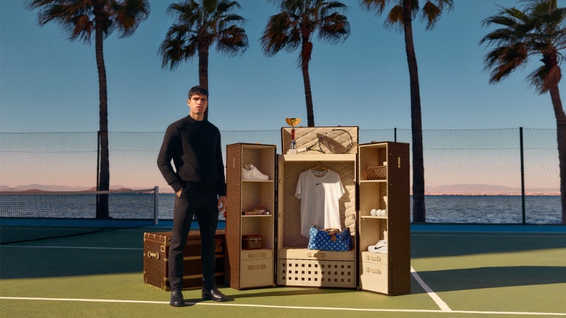 Tennis star Carlos Alcaraz is pictured beside his personalized Louis Vuitton Malle Vestiaire trunk.