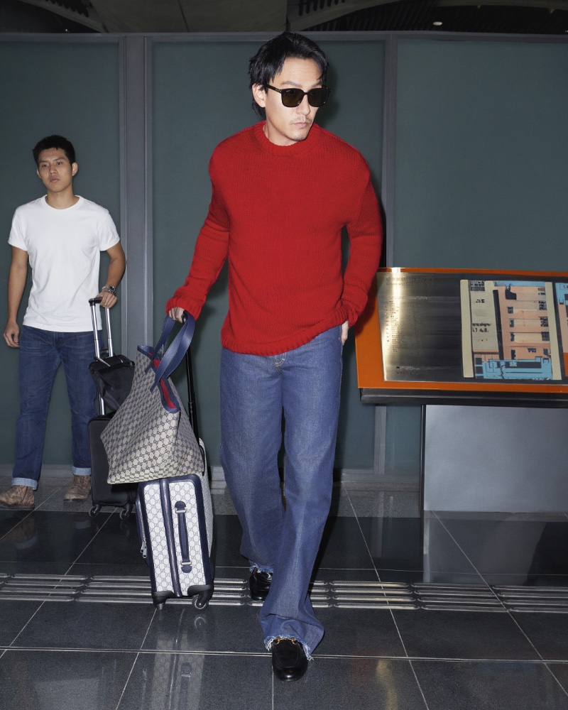 Chang Chen's travel style is highlighted in the Gucci Valigeria 2024 campaign, featuring a pop of color with a red sweater.