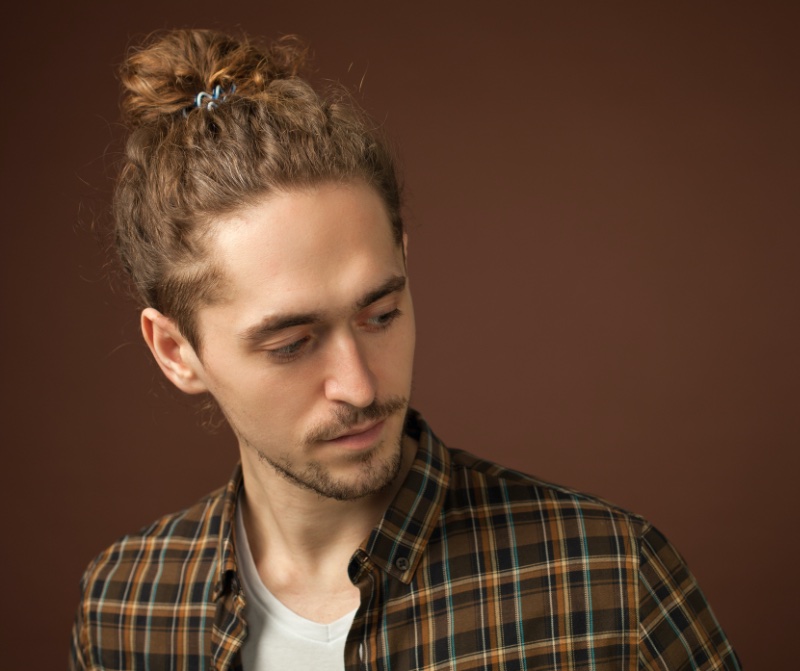 The Curly Hair Man Bun embraces the essence and style of natural texture. 