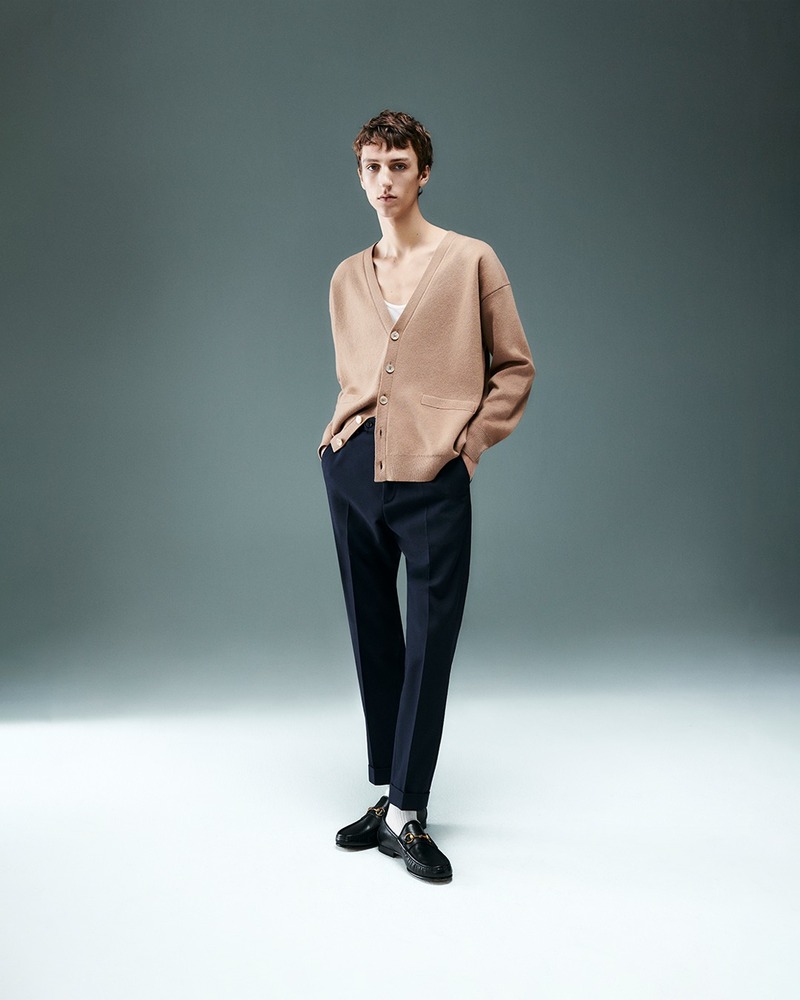 Saul Symon showcases Mytheresa's latest Gucci menswear, featuring a tan cardigan and tailored trousers for the 2024 collection.