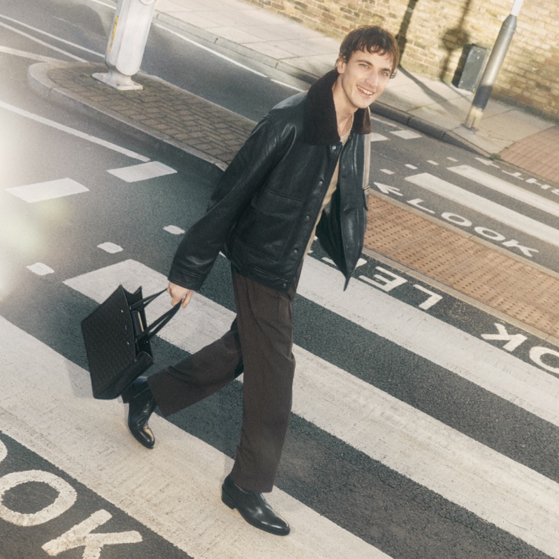 On a stroll, Guy Remmers fronts Jimmy Choo's spring 2024 campaign in Finnion monkstrap shoes.