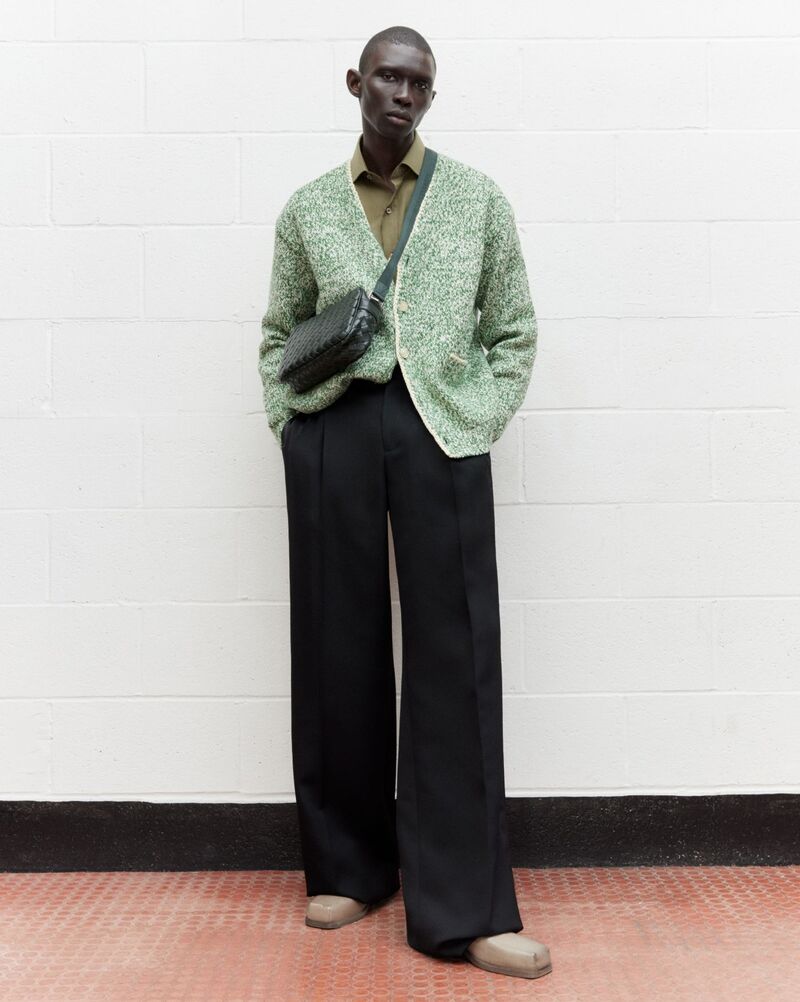 Showcasing men's styles from Matches, Fernando Cabral wears an Auralee cardigan with Alexander McQueen wide-leg trousers. 