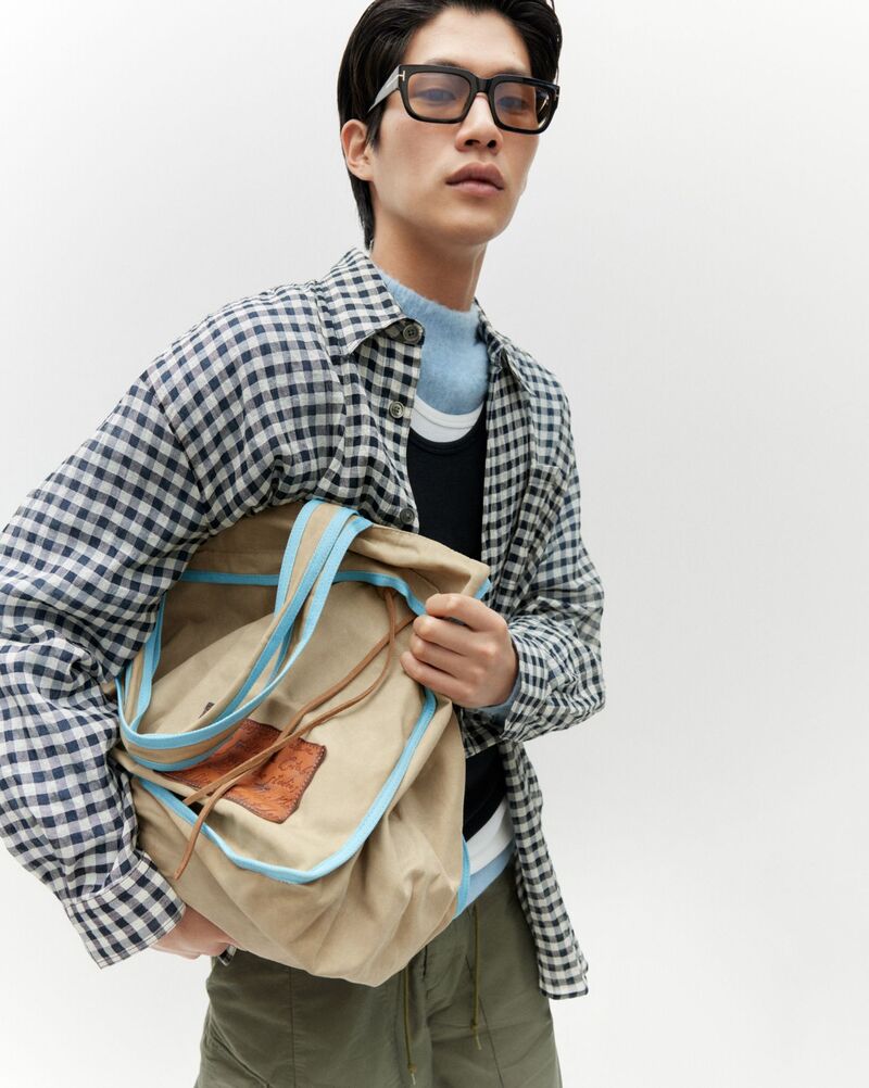 Sanggun Lee layers in an Our Legacy oversized gingham shirt with Manastash trousers from Matches.