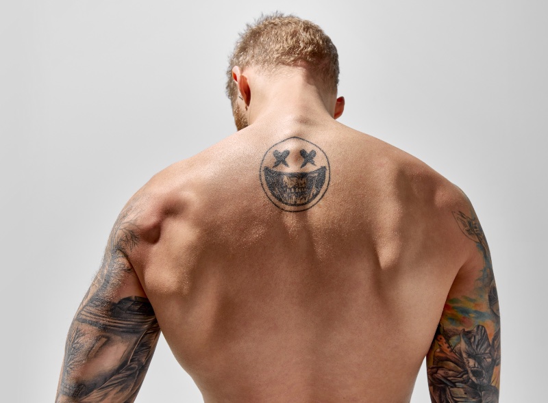 Smiling Skull Back Tattoo Men