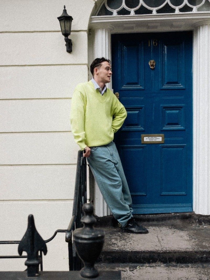 Sonny Hall stands out in Closed, contrasting a soft neon sweater with the urban backdrop for a casually refined look.