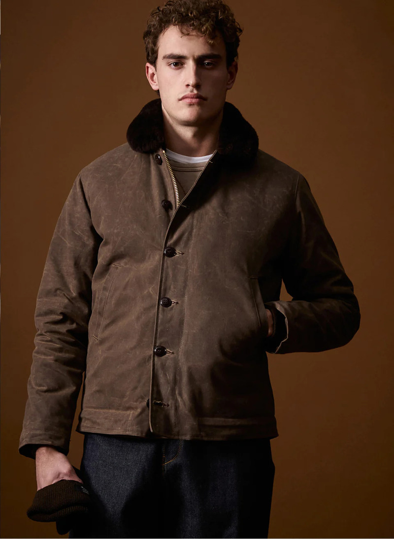 Embracing a rugged charm, Alex Verloop models a Todd Snyder x Denhen waxed cotton shearling jacket.
