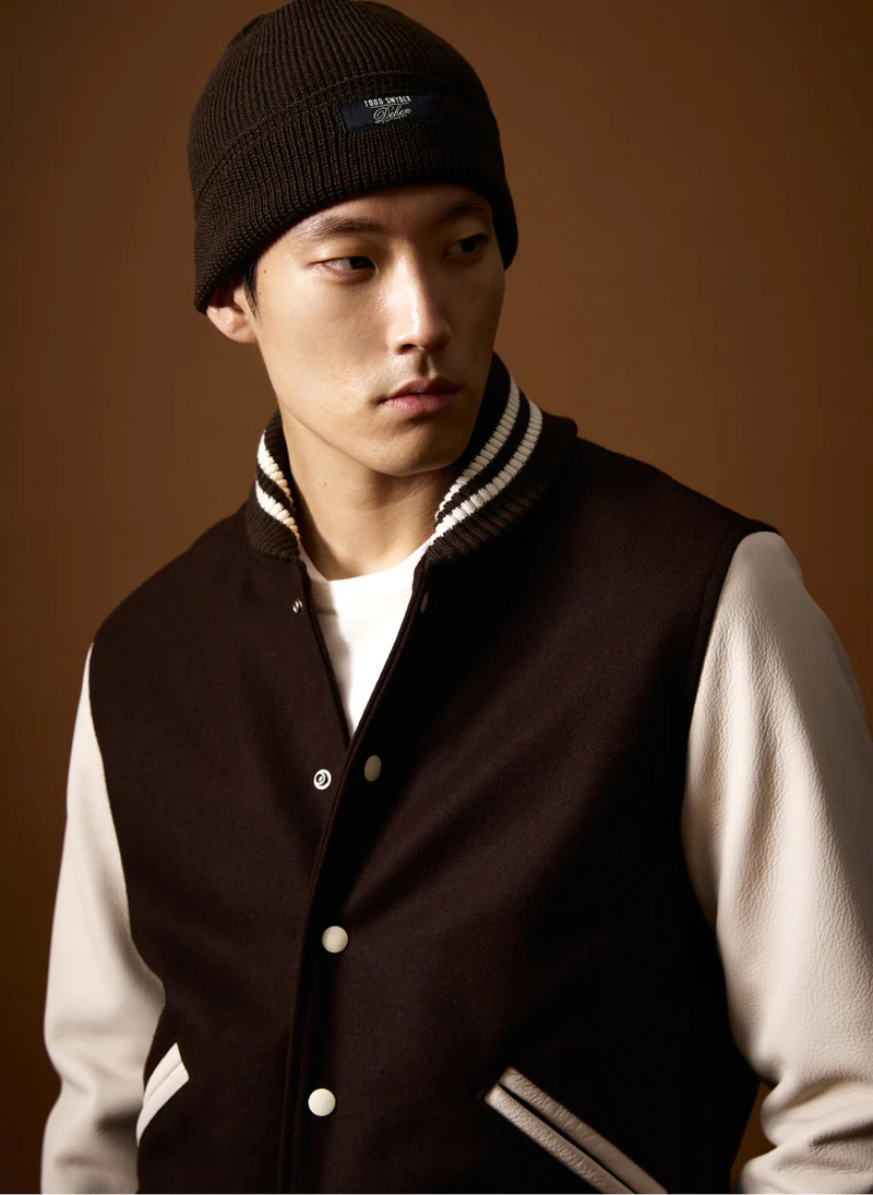 Model Juhyung Kang sports a Todd Snyder x Denhen varsity leather jacket and knit watch cap.
