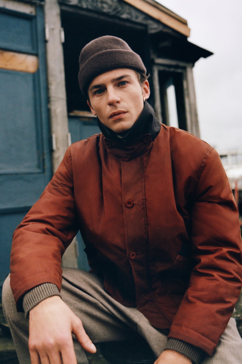 In Zara's latest style outing, Yulef Bopp complements a ribbed beanie with a mixed collar waxed jacket. 