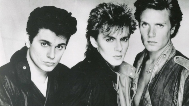 Roger Taylor wears a New Wave pompadour, posing with members of Duran Duran