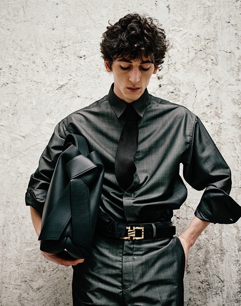 Aslan Tsallatii pairs an Acne Studios shoulder bag with a Ferragamo shirt, pants, and a Double Gancio leather belt for LuisaViaRoma.
