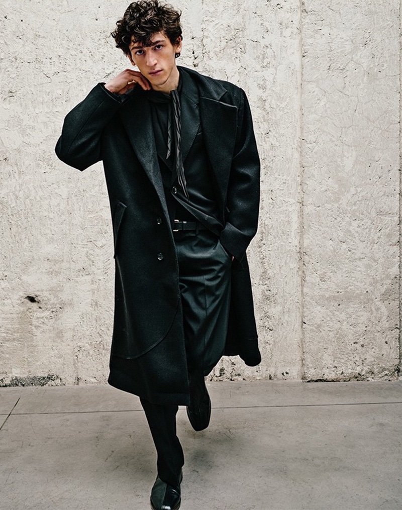 LuisaViaRoma features Aslan Tsallatii, combining a ROUGH. coat with an AMI blazer and Acne Studios pants.