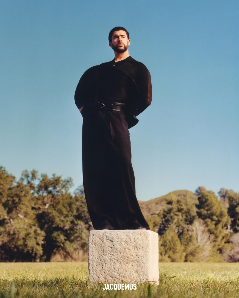 Bad Bunny models a sleek, all-black ensemble for JACQUEMUS' spring-summer 2024 campaign.