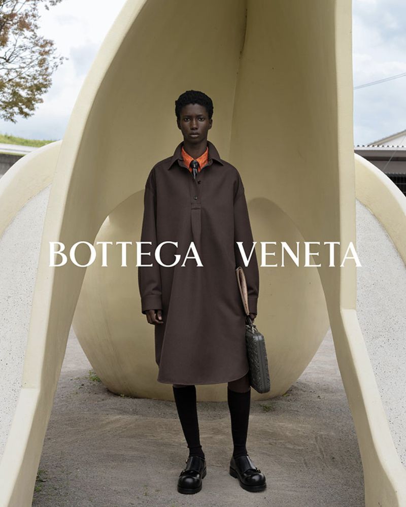 Douta Sidibe poses near a modern sculpture for Bottega Veneta's spring-summer 2024 campaign.