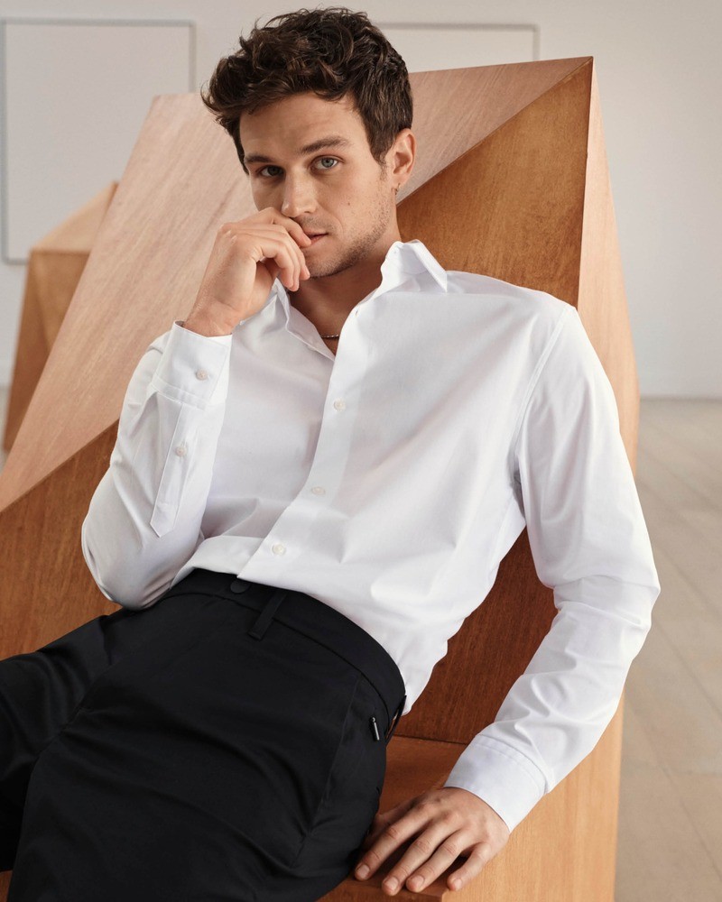 Brandon Flynn captivates in a crisp Calvin Klein white shirt for their spring 2024 campaign, showcasing timeless elegance.
