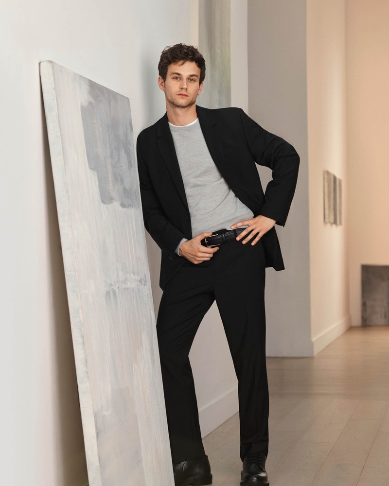 Brandon Flynn dons an elegant black suit for Calvin Klein's spring 2024 campaign. 