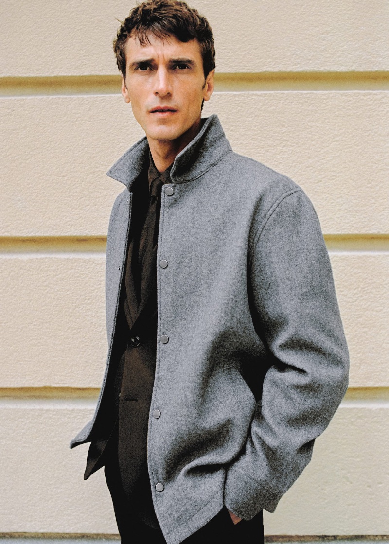 Connecting with Mango, Clément Chabernaud dons a gray snap buttons overshirt.