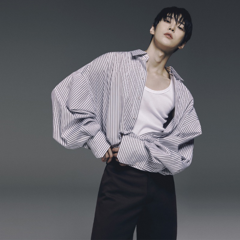 Singer Doyoung makes an oversized statement in a striped shirt for Dolce & Gabbana's spring-summer 2024 ad.