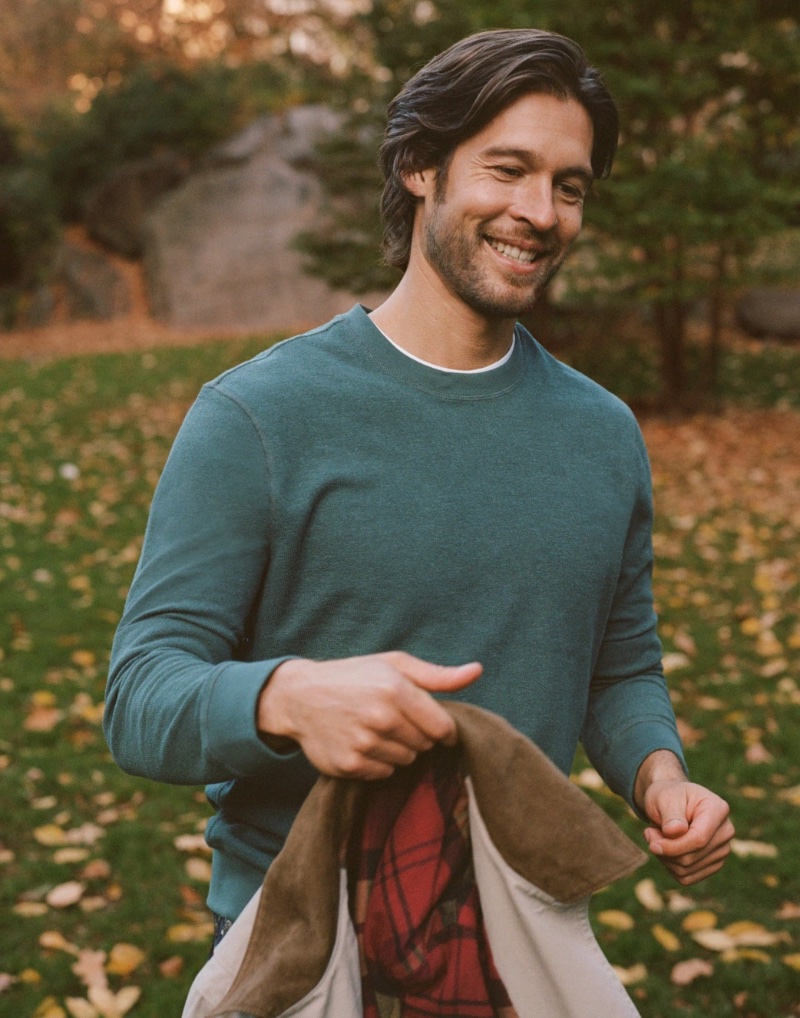 All smiles, Josh Upshaw dons a green long-sleeve textured sweater-tee by J.Crew.