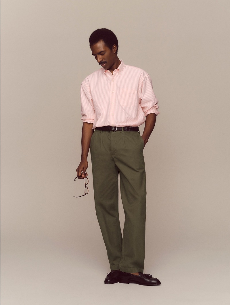 Model Geoff Haggray dons a Giant Oxford shirt with classic double-pleated chinos and Alden for J.Crew cordovan tassel loafers.