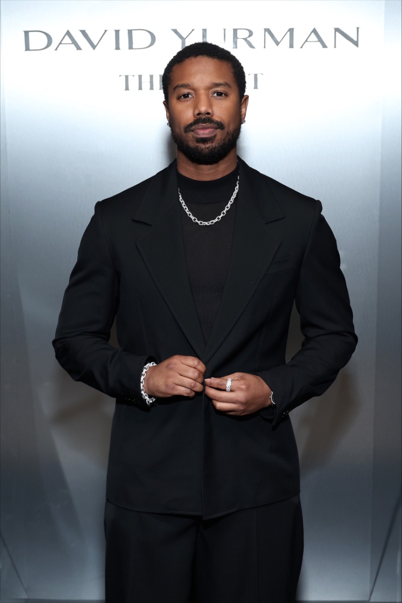 Michael B. Jordan, sharp in a black suit, showcases a chain necklace and bracelet with a ring from The Vault collection at the David Yurman dinner.
