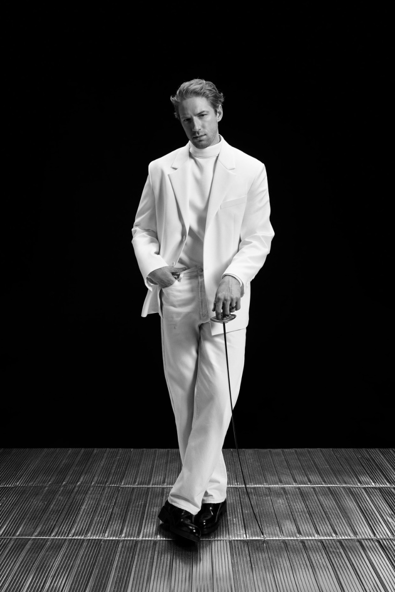 Race Imboden cuts a striking figure in a pristine white Zara outfit.