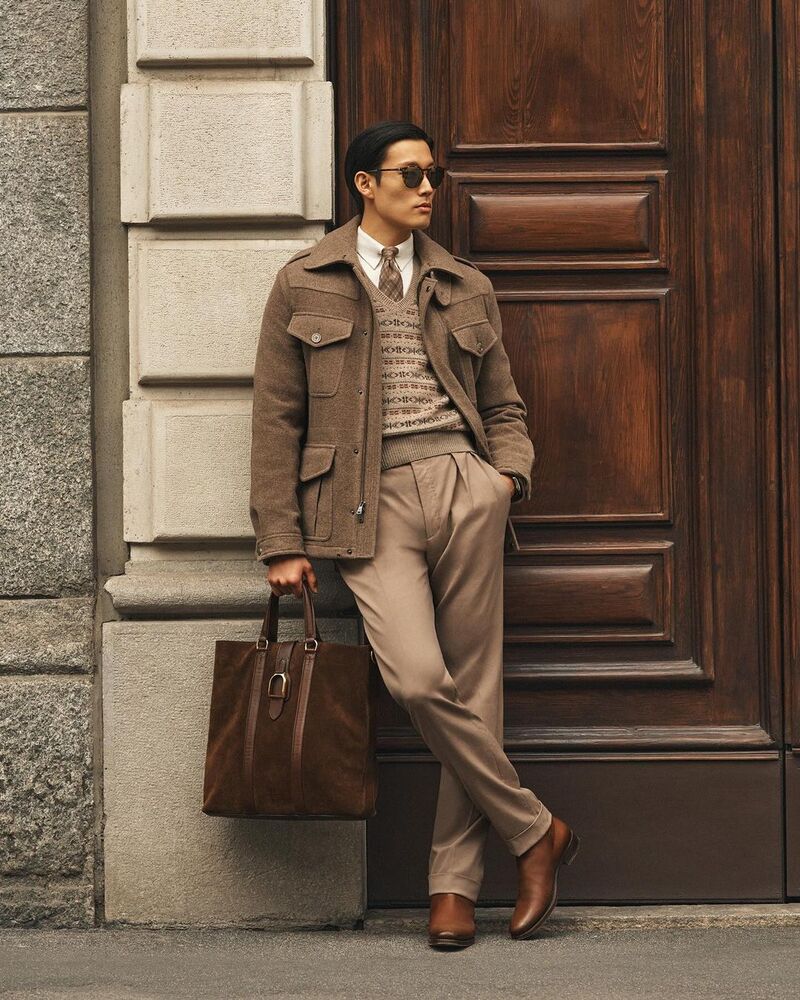 Juhyung Kang embodies effortless elegance in a layered ensemble from Ralph Lauren Purple Label's pre-spring 2024 collection.