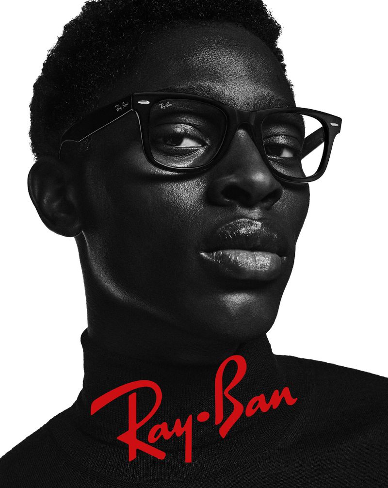 Adamu Bulus makes a bold statement in Ray-Ban's black-and-white ad, sporting sleek black frames with a modern silhouette.