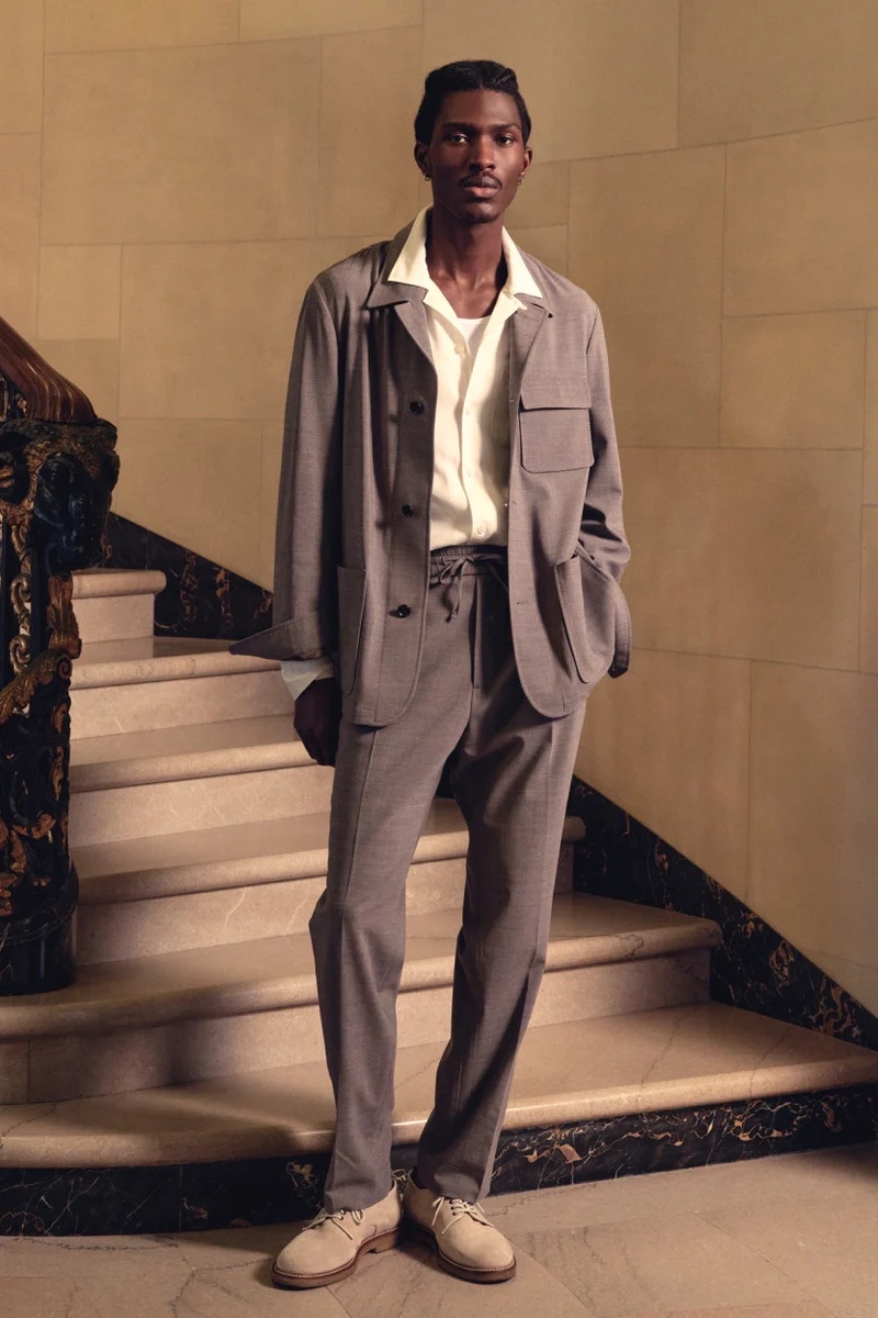 Anarcius Jean models an Italian wool Belmont jacket and Madison drawstring trousers with a long sleeve rayon Hollywood shirt and Nomad derby shoes by Todd Snyder.