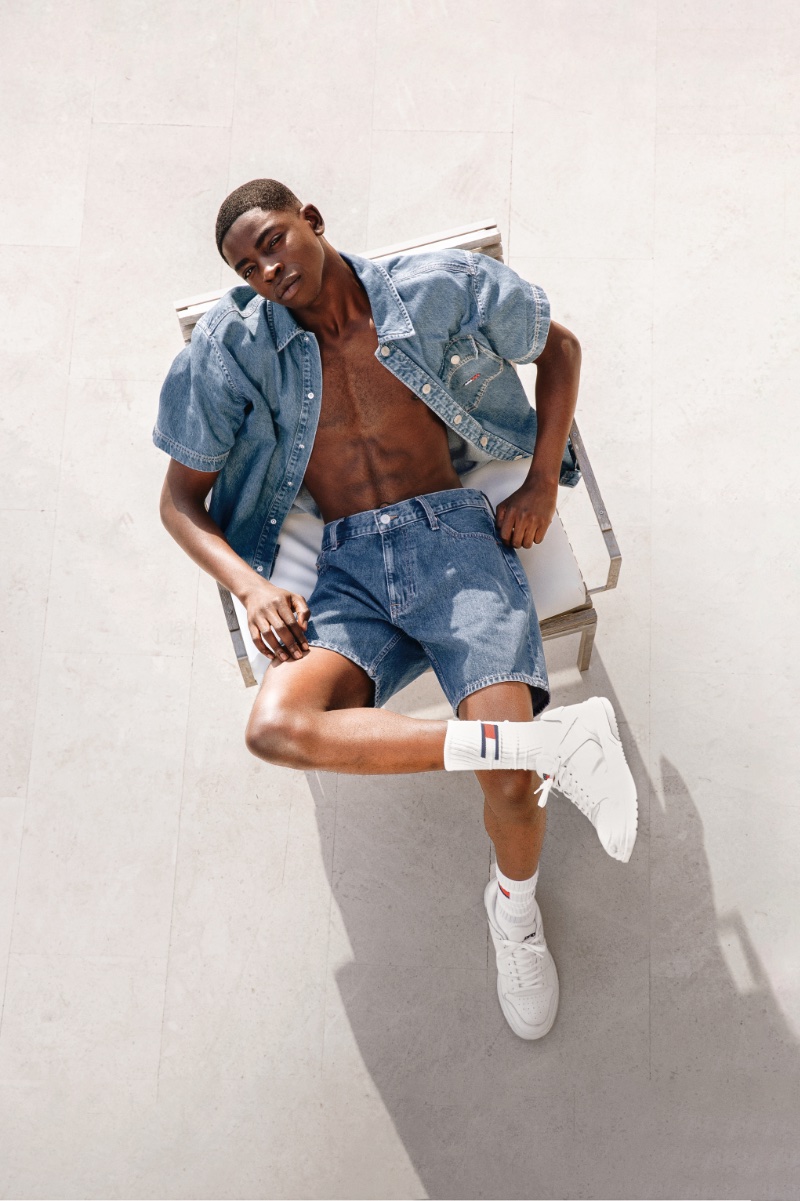 A casual vision, Nelson Gariba rocks denim shorts with a short-sleeve jean jacket for Tommy Jeans' spring 2024 campaign.
