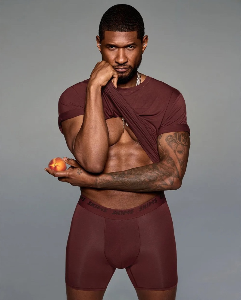 Usher models a maroon set from SKIMS' latest line.