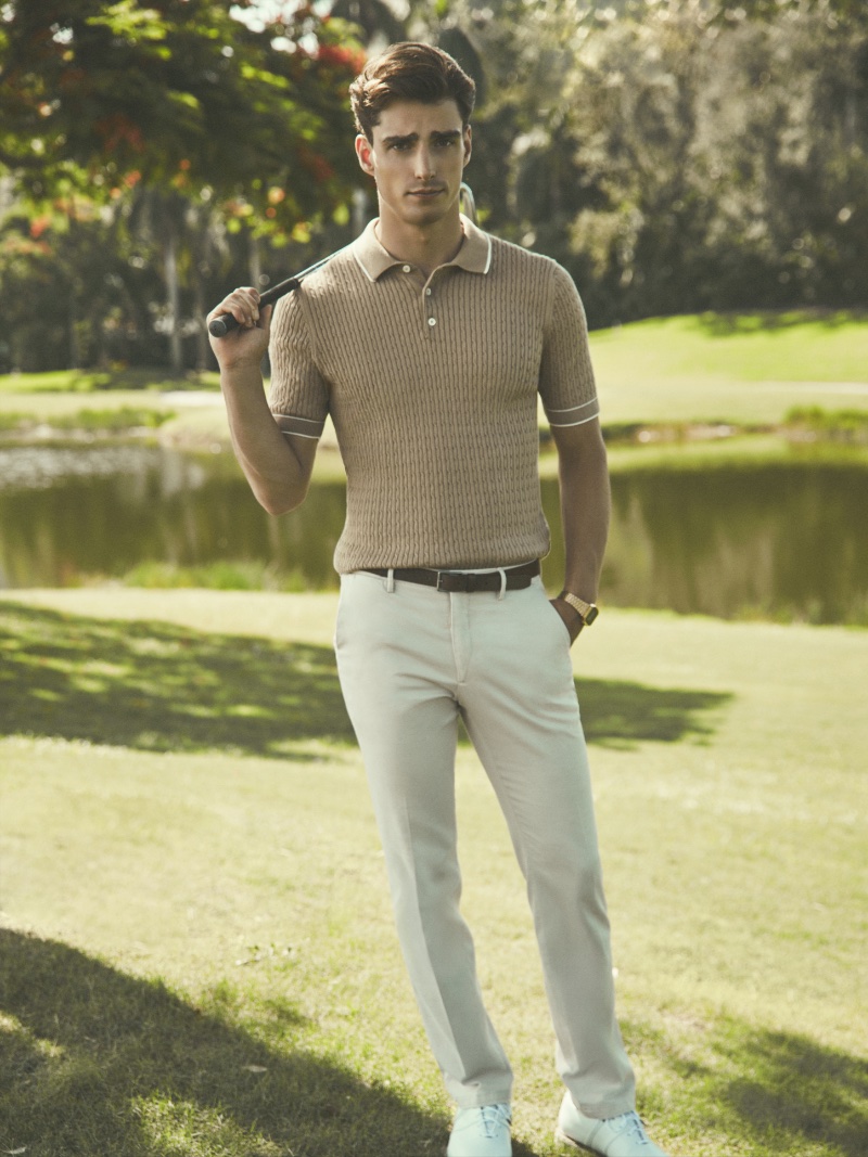 Sporting a ribbed polo, Kane Roberts models a classic golf outfit from BUGATCHI's golf collection. 