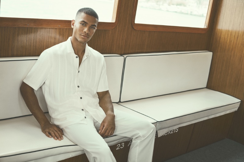 Addis Miller exudes serene sophistication in an all-white BUGATCHI ensemble, perfect for the resort season.