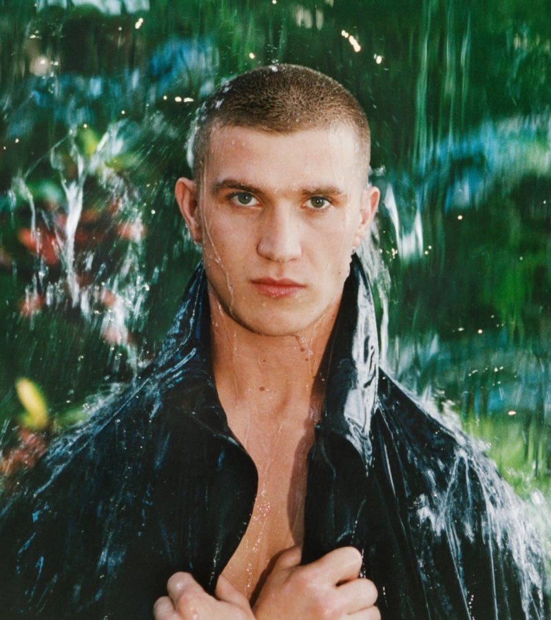 Oisin Murphy captures the essence of Burberry's summer 2024 collection with a piercing gaze and rain-drenched allure.