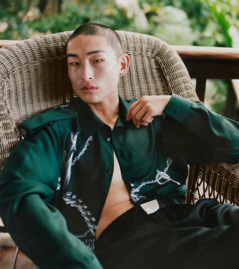 Model Sang Woo Kim relaxes in an elegantly green number for Burberry's summer 2024 campaign.