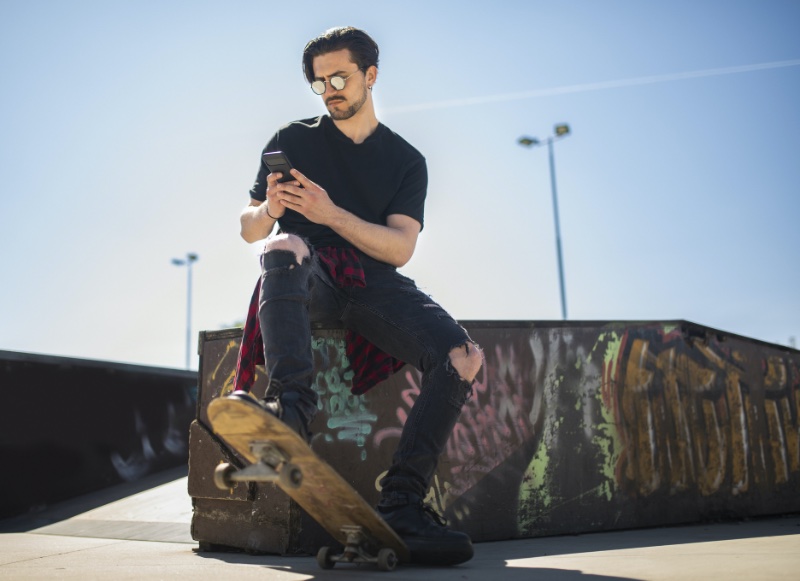 Buying Clothes Online Skateboard Man Phone Skatepark