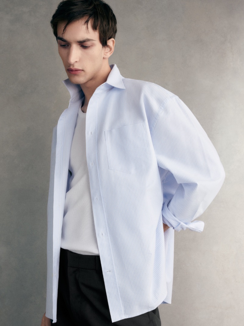 Model Habib Masovic sports a wide Oxford shirt from COS' spring 2024 collection.