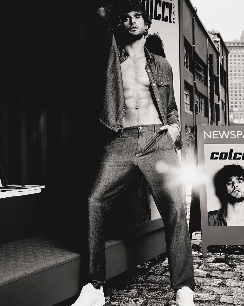 Marlon Teixeira poses in double denim for the Colcci fall 2024 campaign.